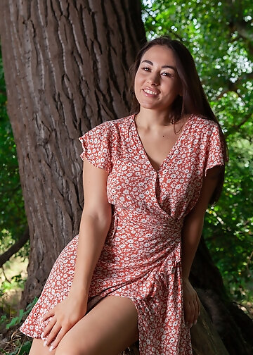 A woman Sumiko in the woods takes off her light dress and poses nude