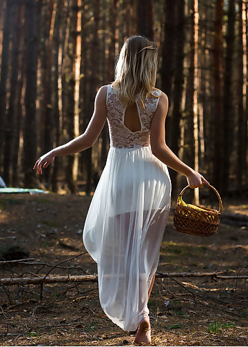 Cute girl takes clothes off to reveal smooth vagina in the forest