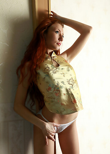 Stunning redhead slowly strips naked