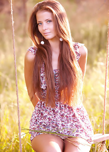 Young enchantress with red hair decides to undress because it's too hot