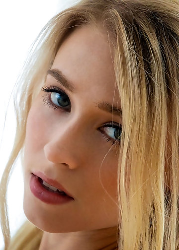 Delicious long-haired blonde with small perky tits poses naked and shows her pussy