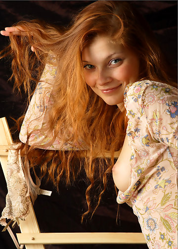 Red-haired belle not shy to show her medium tits and pussy