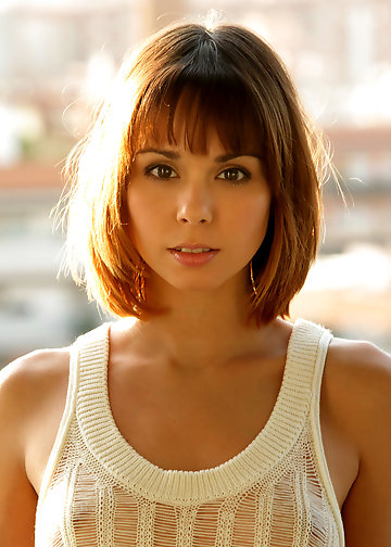 Petite charmer doesn't mind having fun on the balcony