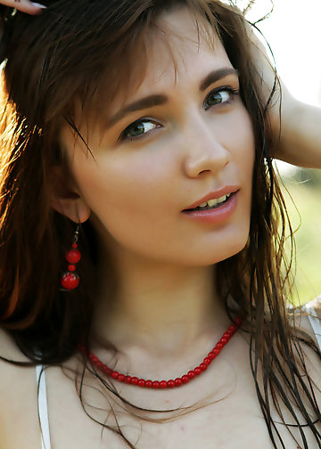 Slender tough chick with tattooed leg poses naked in the fresh air