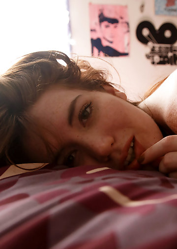 Babe with naughty eyes wears tight pantyhose while posing in bed