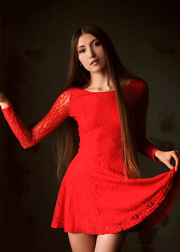 Slender teen in red dress showing bald pussy on the chair