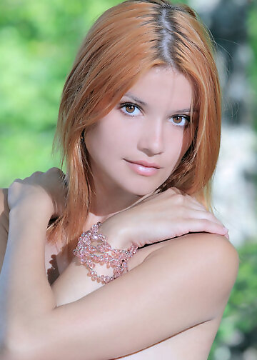Nude red-haired beauty in the woods